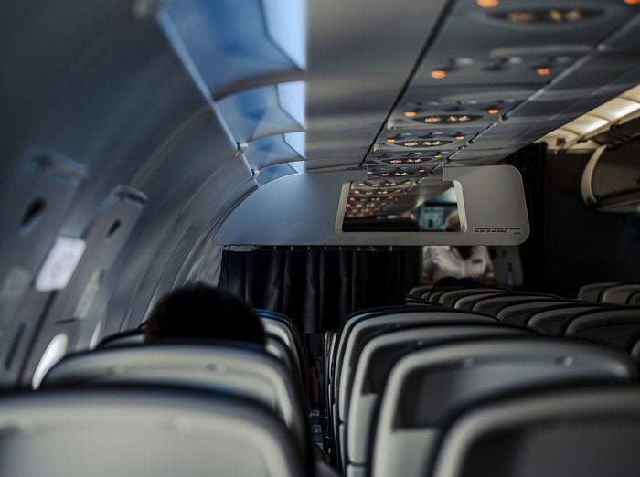 Interior of empty seats on a airplane. only a few passengers sit in the empty plane
