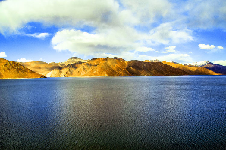 Scenic view of pangong tso and mountains against sky