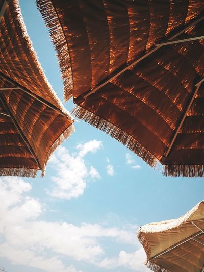 Low angle view of thatched roof against sky