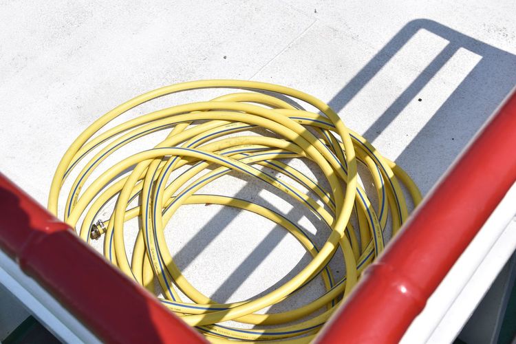 High angle view of garden hose on building terrace
