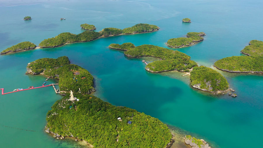 Islands in blue water covered with vegetation with beaches and bays where tourists rest. 