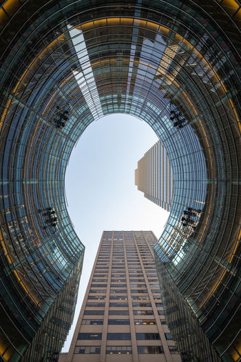 Low angle view of modern skyscraper against clear sky