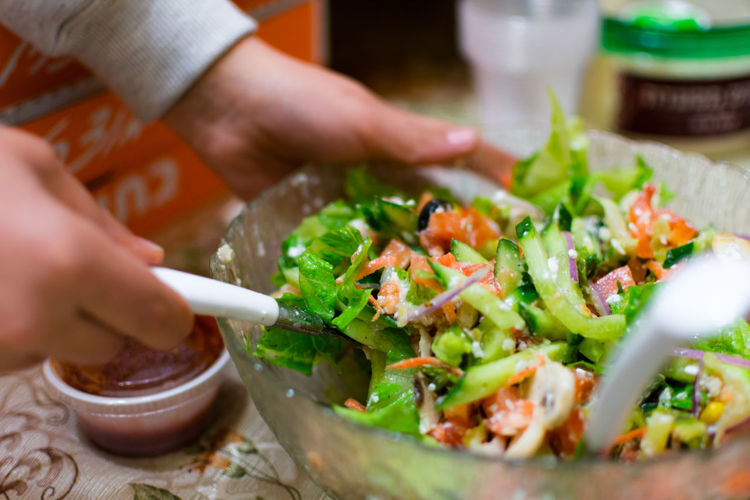 Close-up of hand mixing food in bowl