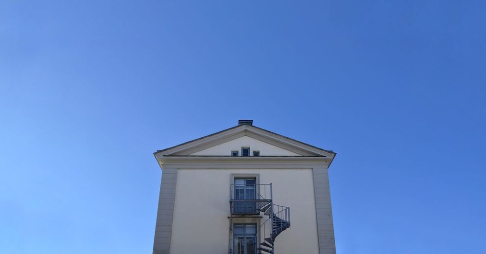 Low angle view of building against blue sky