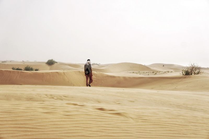 Full length of woman standing on landscape
