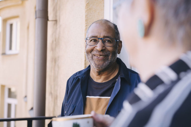 Smiling man looking at woman in balcony