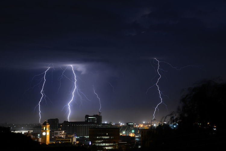 View of lightning over city at night