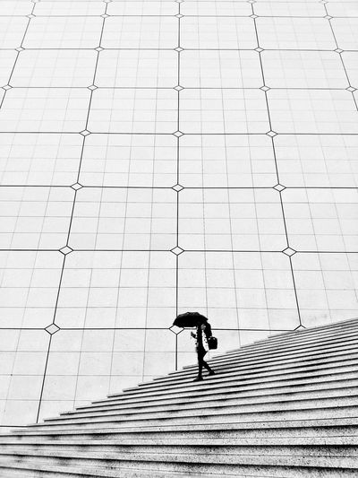 High angle view of woman walking on staircase