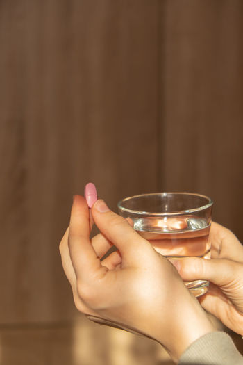 Cropped hand of woman holding wineglass