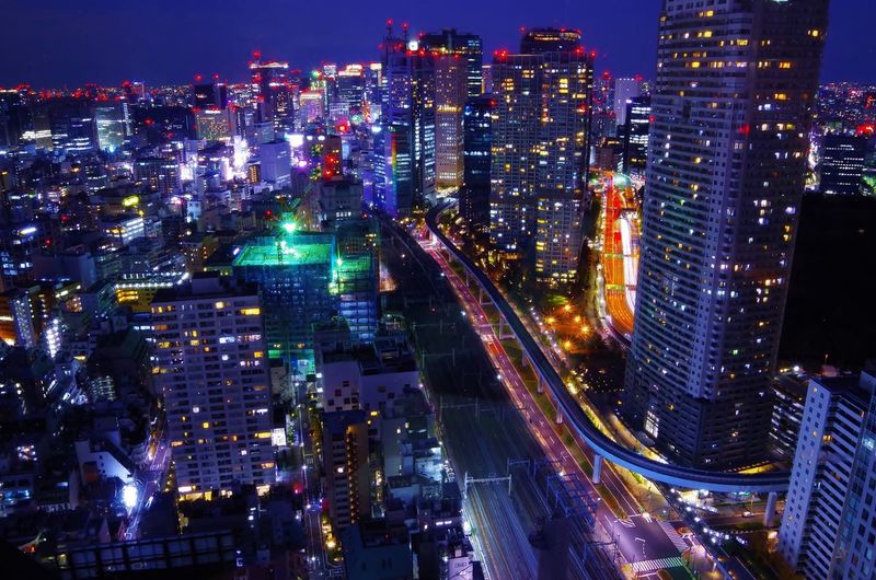 Aerial view of city lit up at night