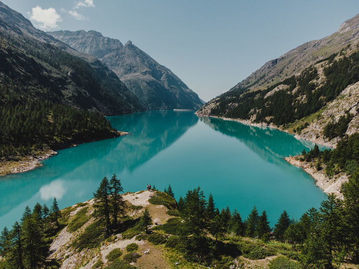 Scenic view of lake and mountains against sky