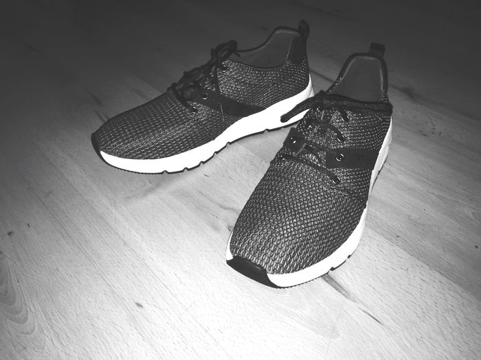 High angle view of shoes on hardwood floor at home