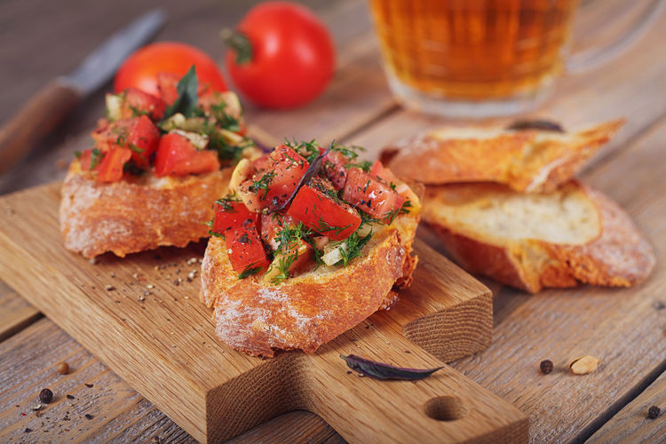 Italian bruschetta with chopped tomatoes, basil, herbs and olive oil on grilled crusty bread