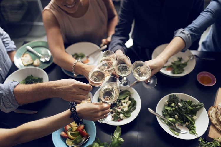 High angle view of multi-ethnic friends toasting wineglasses