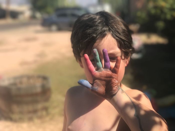 Boy showing colorful hand