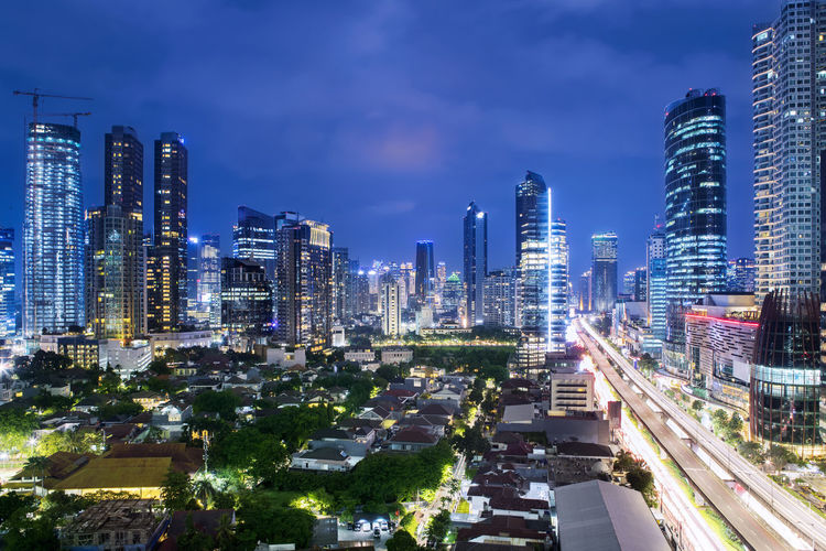 High angle view of illuminated buildings in city against sky