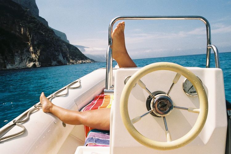 Person relaxing on boat on the sea