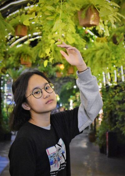 Portrait of boy standing by plants