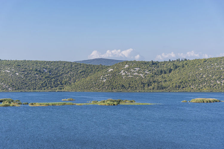 Scenic view of sea against blue sky