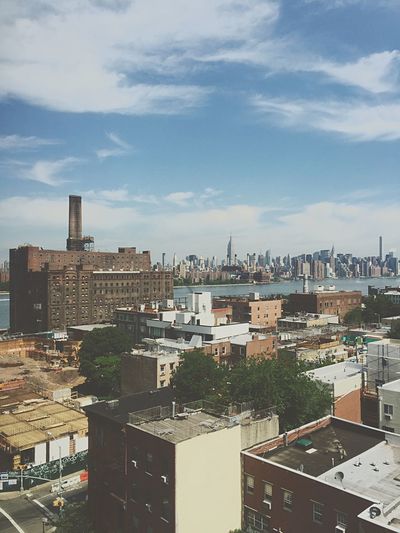 Buildings against cloudy sky