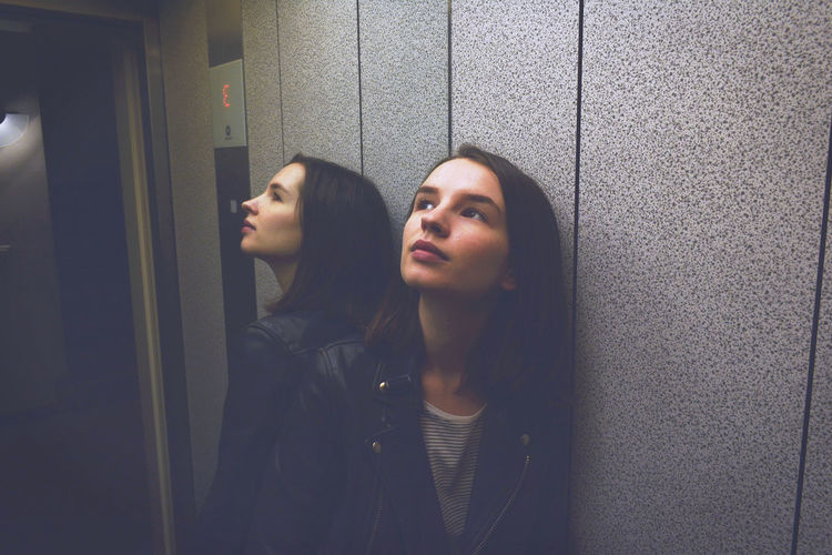 Woman looking up while standing in elevator