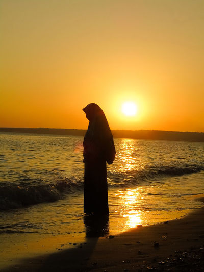 Siluet a women on the beach at sunset