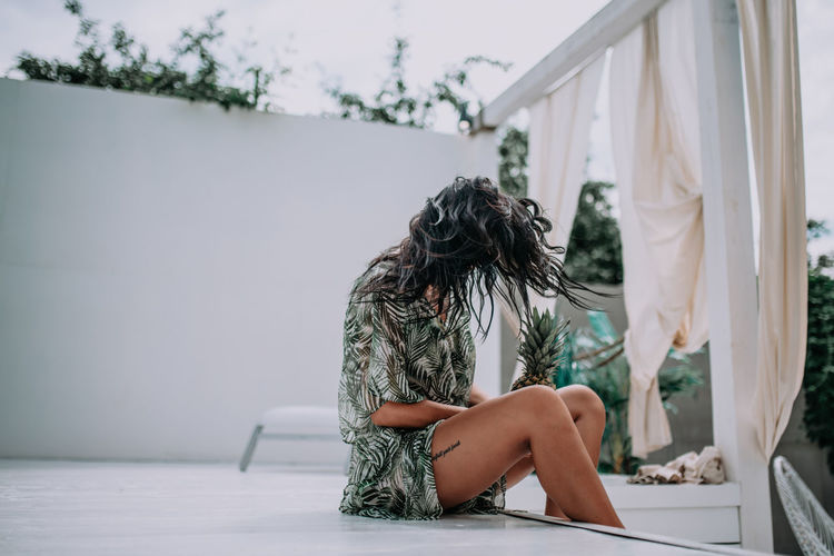 Rear view of woman sitting on seat