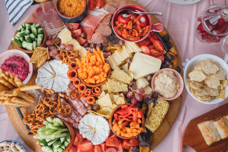 Platter of healthy party food taken from above, vibrant and colourful carrots, crackers and cheese