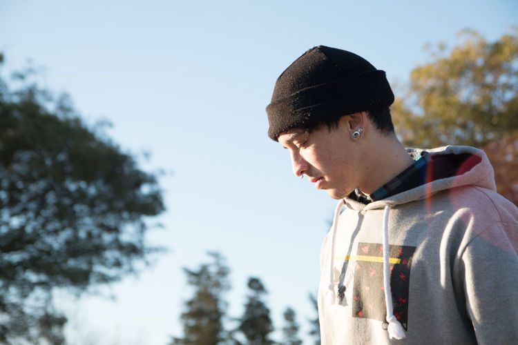 Portrait of boy looking away against sky