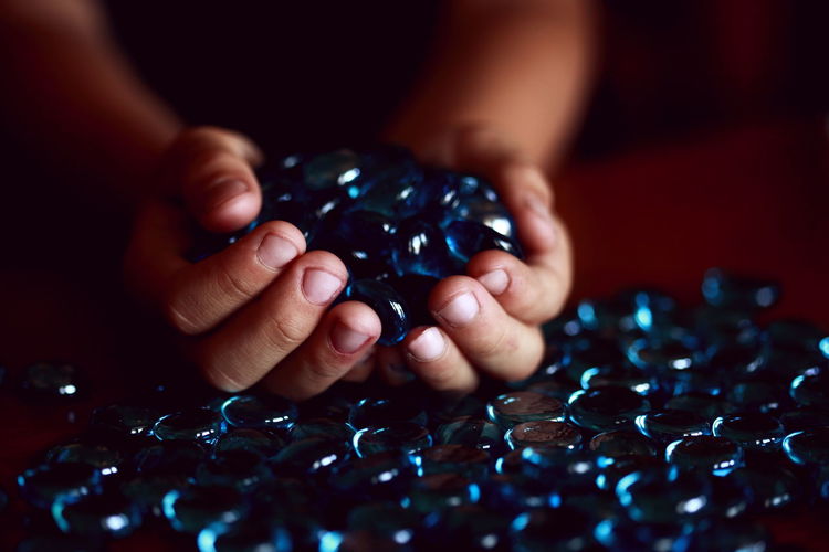 Cropped image of person holding beads