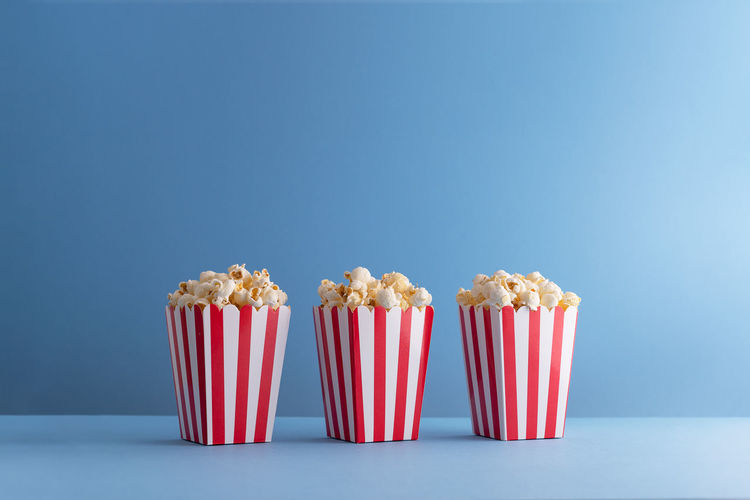 Close-up of cupcakes on table against blue background