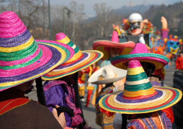 People wearing colorful hats during event in city