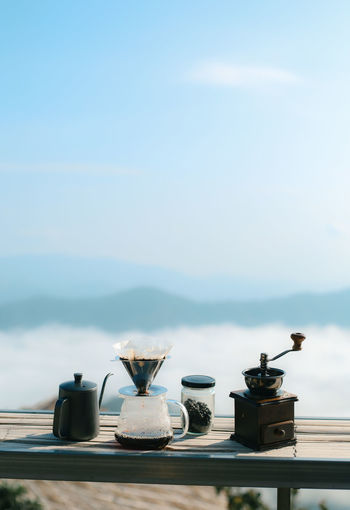 Coffee maker on table against sky