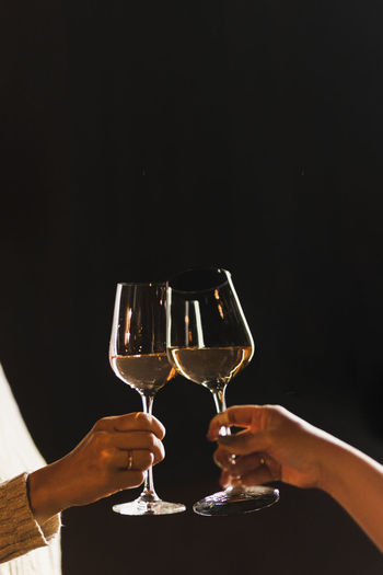 Cropped hand holding wineglass