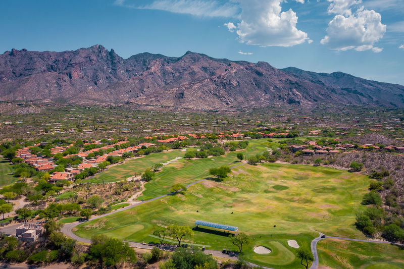 Golf course in catalina foothills with mountain range in distance.