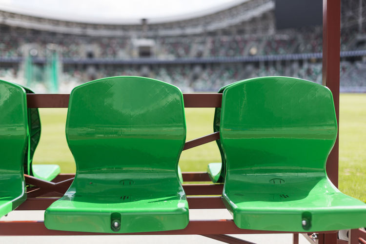 Close-up of empty seats in stadium